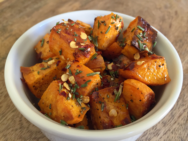 Spicy, salty, herbal, sweet: roasted sweet potatoes with a drizzle of local honey, crushed red pepper, ground sea salt, and fresh rosemary.